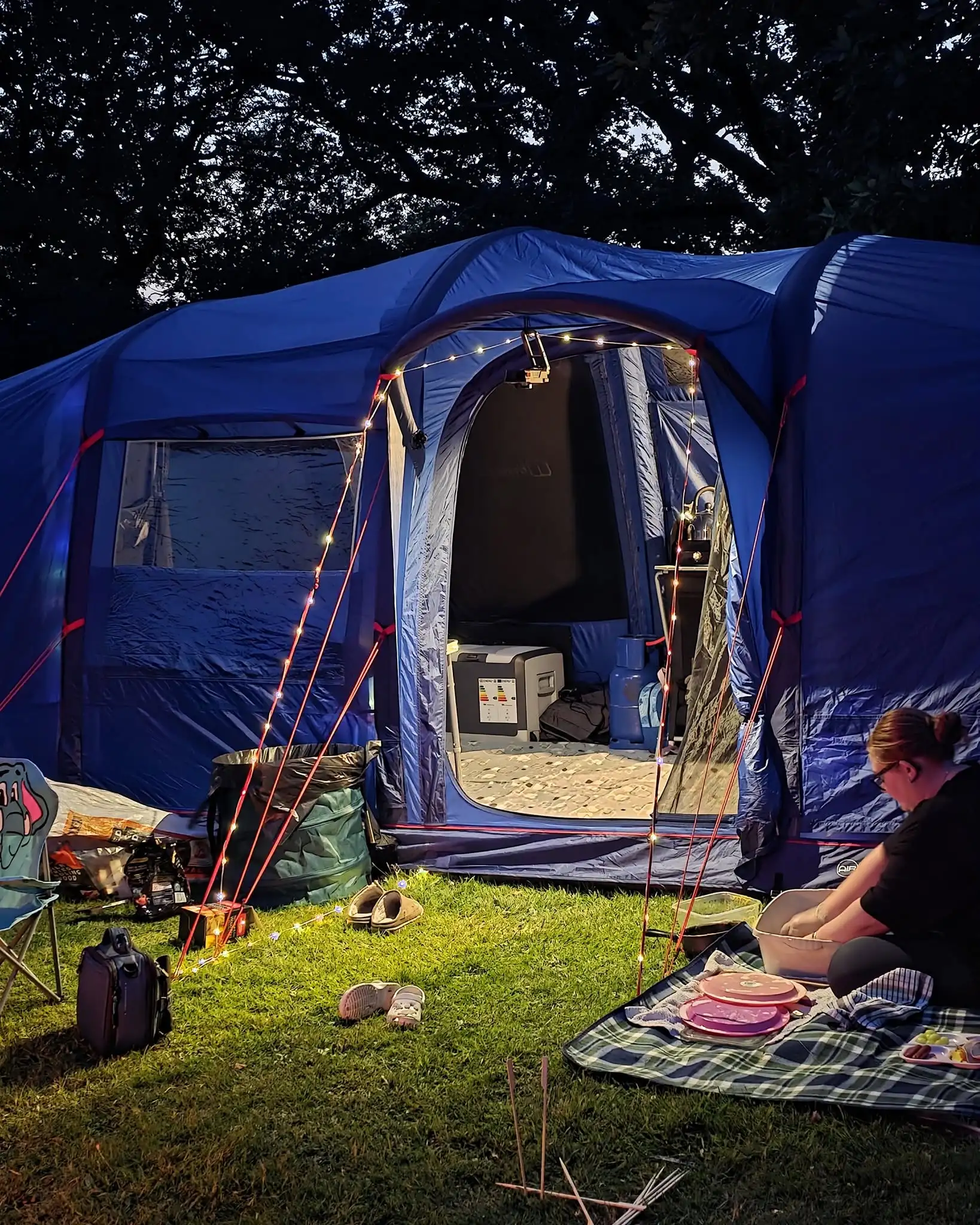 Inside a tent lit for the evening