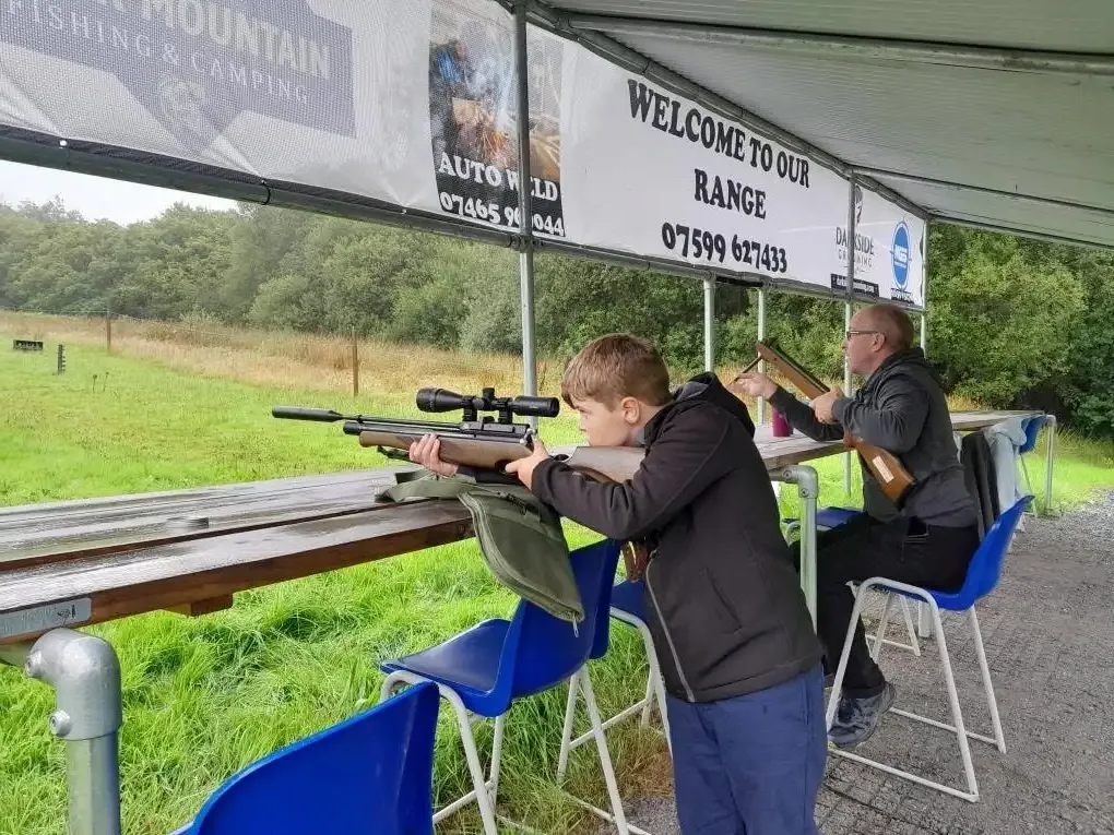 Shooters at the bench on the air rifle range