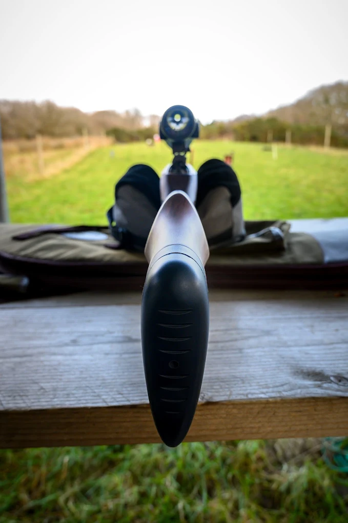 An air rifle resting on the bench at the range